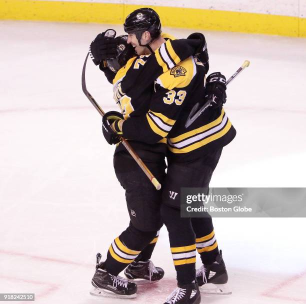 Boston Bruins' Zdeno Chara and Boston Bruins defenseman Charlie McAvoy share an embrace after Chara's empty net goal sealed the 5-2 win. The Boston...