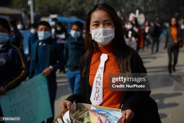 Nepalese youth and students demonstrate as they participate in campaign Maskmandu against the increasing air pollution in Kathmandu, Nepal, February...