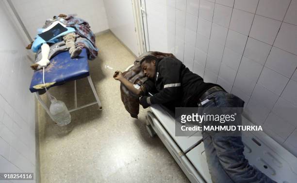 African migrant, who were injured after their vehicle was overturned during a truck collision, sleep on beds in a hospital room in the town of Beni...