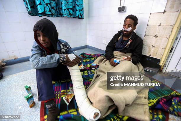 African migrants who were injured after their vehicle was overturned during a truck collision, sit in a room after receiving medical treatment at a...