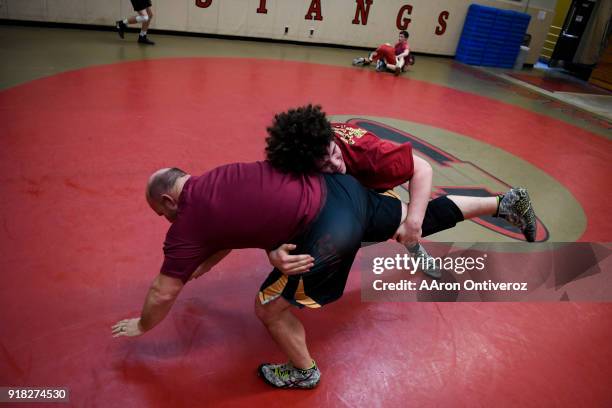 Ponderosa High School wrestling phenom Cohl Schultz works a double leg takedown against assistant coach Dusty Hoffschneider during practice on...