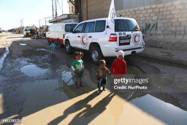 Children standing beside the Syrian Arab Red Crescent, while entering convoys of aid to the people in the eastern Ghouta A United Nations and Syrian...