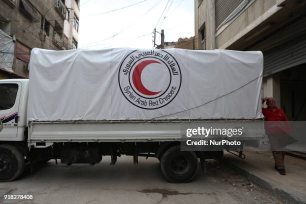 United Nations and Syrian Red Crescent inter-agency convoy delivers aid to Douma in the Syrian rebel enclave of Eastern Ghouta on February 14, 2018....