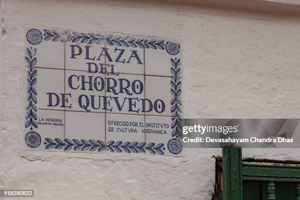 bogotá, colombia - ceramic sign indicates the small square called plaza del chorro de quevedo in the historic la candelaria district of the andean capital city - plaza del chorro de quevedo stock pictures, royalty-free photos & images