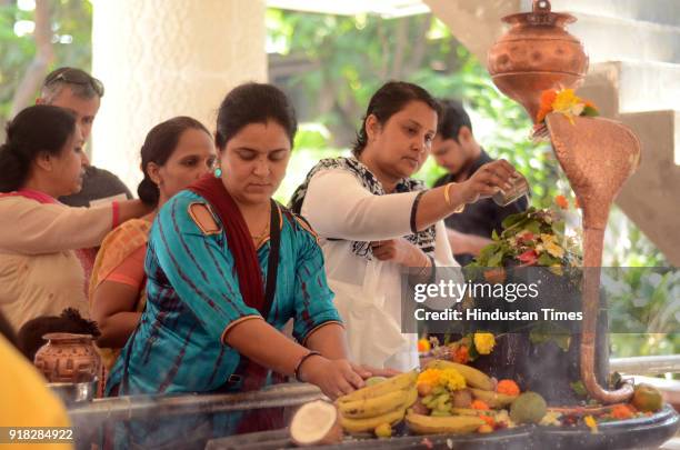 Devotee offer milk to a shivling at Bengali Kalibaari on the ocassion of Maha Shivratri at Vashi, on February 13, 2018 in Mumbai, India. People...