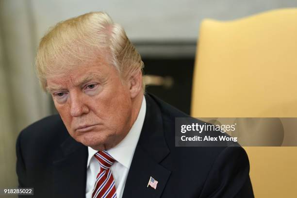 President Donald Trump listens during a working session regarding the Opportunity Zones provided by tax reform in the Oval Office of the White House...