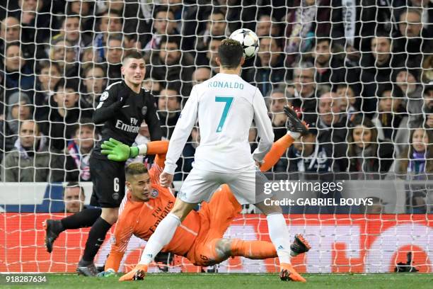 Real Madrid's Portuguese forward Cristiano Ronaldo vies with Paris Saint-Germain's French goalkeeper Alphonse Areola and Paris Saint-Germain's...