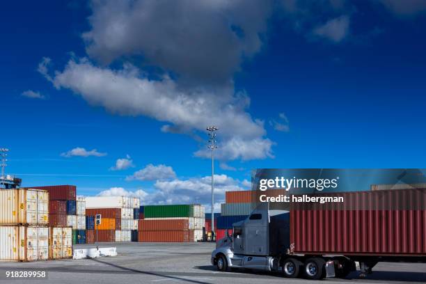 truck driving through shipping terminal - containers harbour stock pictures, royalty-free photos & images