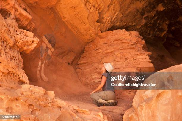 woman hiker admires all american man rock art canyonlands national park pueblo ruin utah - canyonlands national park stock pictures, royalty-free photos & images