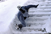 A woman slips and fell on a wintry staircase