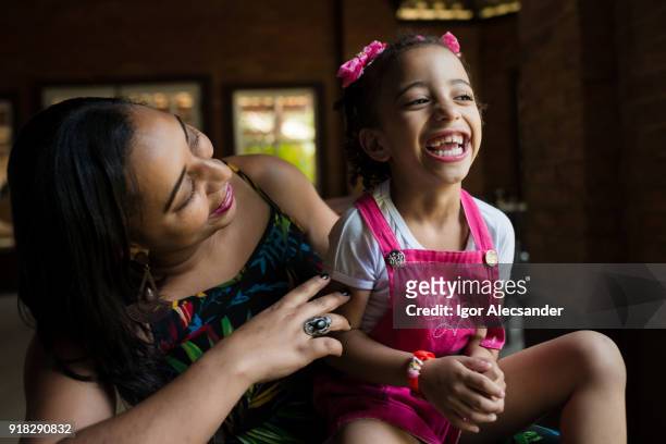 mother and daughter having fun at home - moving down to seated position stock pictures, royalty-free photos & images