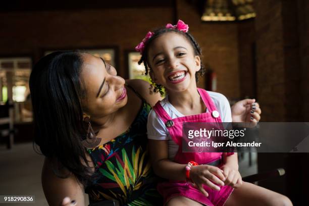 mother and daughter having fun at home - moving down to seated position stock pictures, royalty-free photos & images