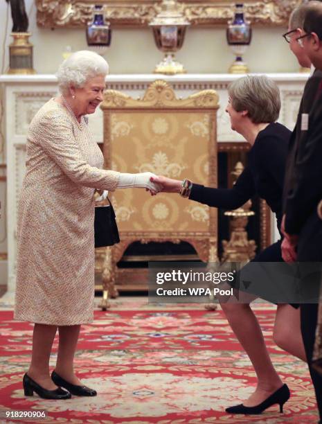 Queen Elizabeth II greets Prime Minister Theresa May at a reception to celebrate the Commonwealth Diaspora community, in the lead up to the...