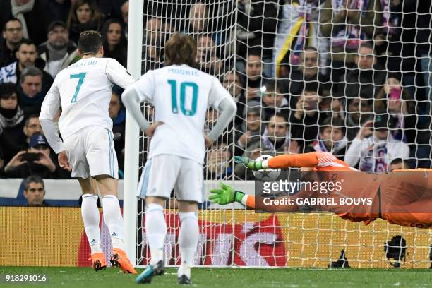 Real Madrid's Portuguese forward Cristiano Ronaldo scores a penalty againt Paris Saint-Germain's French goalkeeper Alphonse Areola during the UEFA...