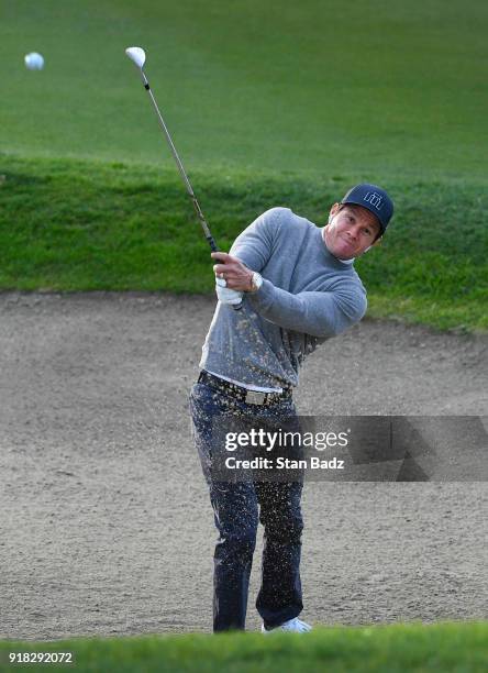 Mark Wahlberg plays a bunker shot during Pro-Am round for the Genesis Open at Riviera Country Club on February 14, 2018 in Pacific Palisades,...