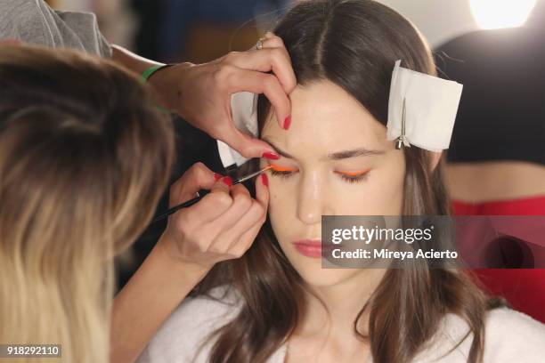 Model prepares backstage at the Maryam Nassir Zadeh fashion show during New York Fashion Week on February 14, 2018 in New York City.