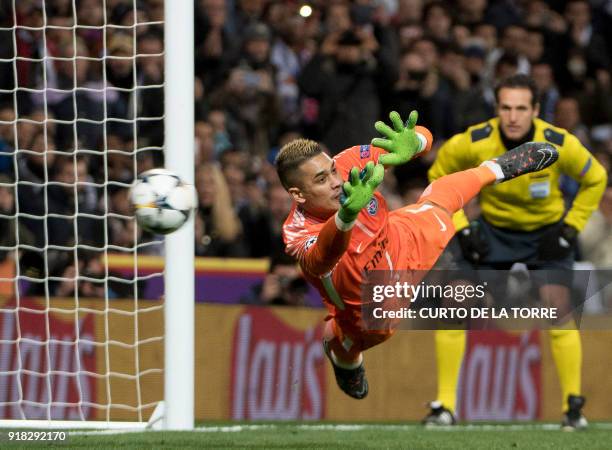 Paris Saint-Germain's French goalkeeper Alphonse Areola concedes a goal during the UEFA Champions League round of sixteen first leg football match...