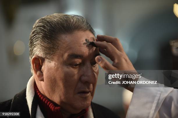 Catholic faithful participates in the traditional Ash Wednesday ceremony at the Metropolitan Cathedral in downtown Guatemala City on February 14,...