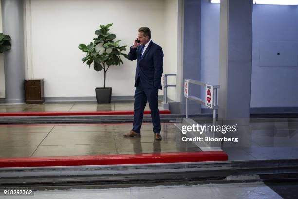 Senator Jeff Flake, a Republican from Arizona, speaks on a mobile device while waiting for the Senate Subway in the basement of the U.S. Capitol in...