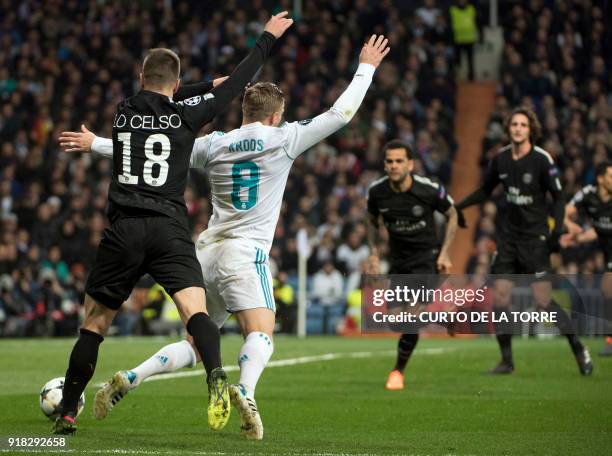 Paris Saint-Germain's Argentinian midfielder Giovani Lo Celso tackles Real Madrid's German midfielder Toni Kroos leading to a penalty during the UEFA...