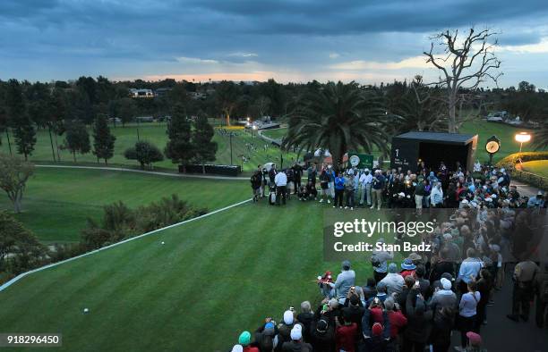 Fans watch Tiger Woods hitting a tee shot on the first hole during the Pro-Am round for the Genesis Open at Riviera Country Club on February 14, 2018...