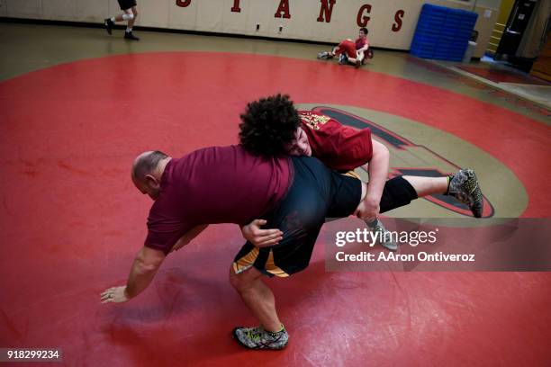 Ponderosa High School wrestling phenom Cohl Schultz works a double leg takedown against assistant coach Dusty Hoffschneider during practice on...