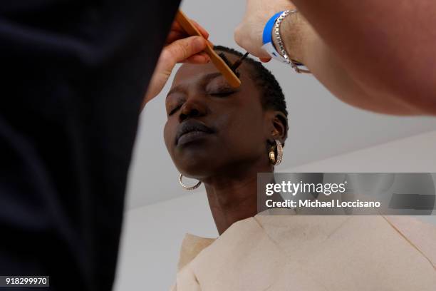 Model prepares backstage for Esteban Cortazar during New York Fashion Week: The Shows at Gallery I at Spring Studios on February 14, 2018 in New York...