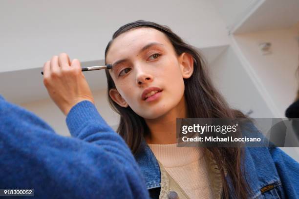 Model prepares backstage for Esteban Cortazar during New York Fashion Week: The Shows at Gallery I at Spring Studios on February 14, 2018 in New York...