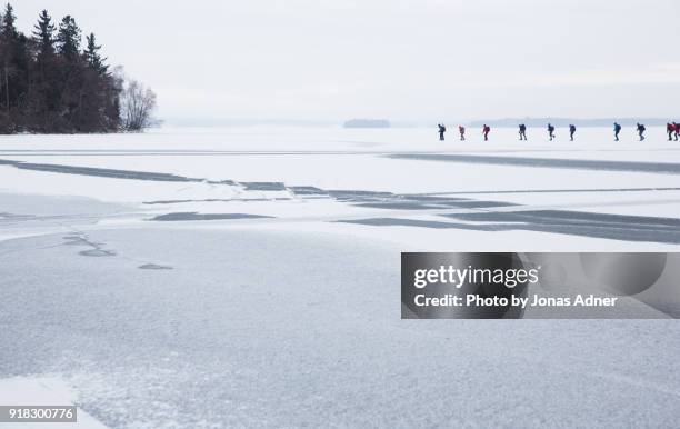 the line of iceskaters - jonas adner stock pictures, royalty-free photos & images