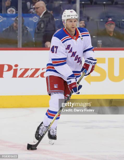 Steven Kampfer of the New York Rangers takes part in the pre-game warm up prior to NHL action against the Winnipeg Jets at the Bell MTS Place on...