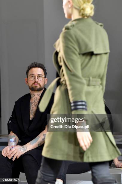 Designer Marcel Ostertag and a model prepare backstage for Marcel Ostertag front row during New York Fashion Week: The Shows at Gallery II at Spring...