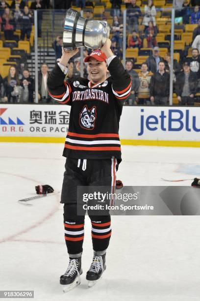 Northeastern Huskies forward Dylan Sikura raises the Beanpot Trophy. During the Northeastern Huskies game against the Boston University Terriers at...