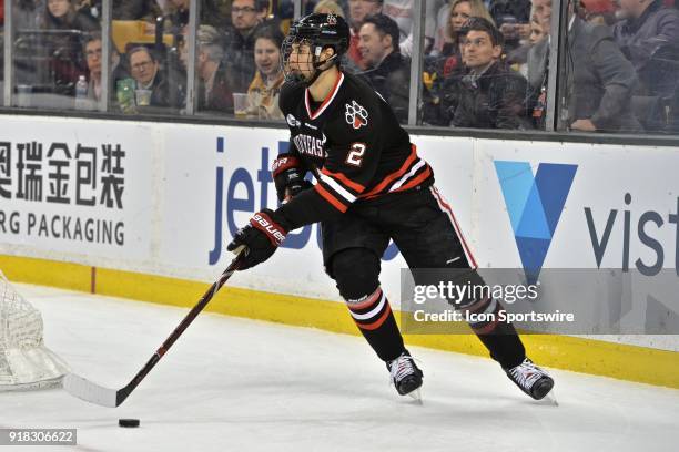 Northeastern Huskies defenseman Trevor Owens brings the puck around the back of the net. During the Northeastern Huskies game against the Boston...