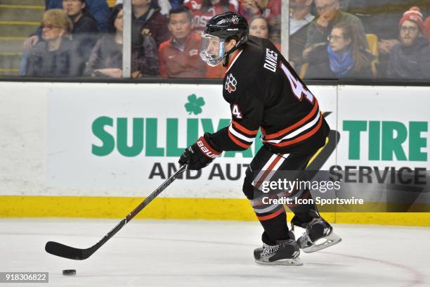 Northeastern Huskies defenseman Jeremy Davies brings the puck up ice. During the Northeastern Huskies game against the Boston University Terriers at...