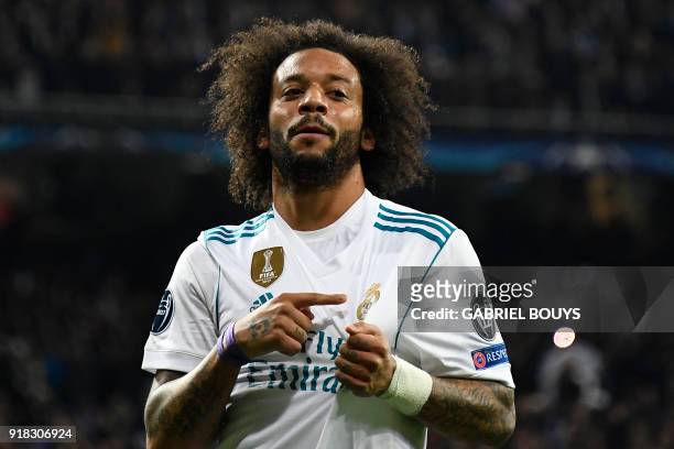 Real Madrid's Brazilian defender Marcelo celebrates after scoring during the UEFA Champions League round of sixteen first leg football match Real...