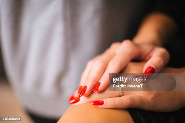 beautiful wedding ring on brides hand with red nails coloured - jovanat stock pictures, royalty-free photos & images