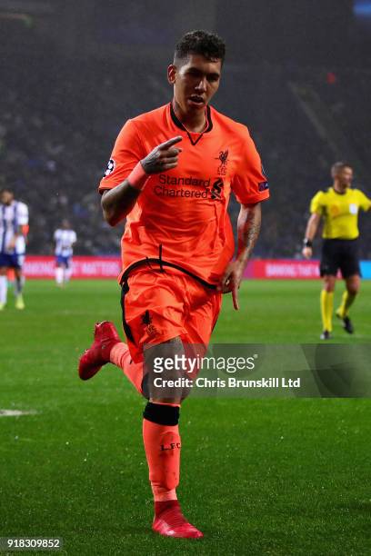 Roberto Firmino of Liverpool celebrates after scoring his sides fourth goal during the UEFA Champions League Round of 16 First Leg match between FC...
