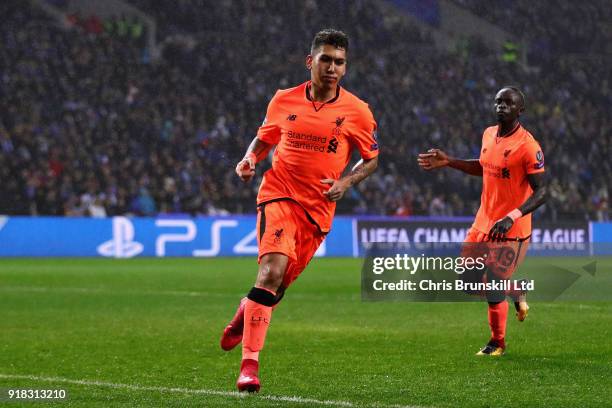 Roberto Firmino of Liverpool celebrates after scoring his sides fourth goal during the UEFA Champions League Round of 16 First Leg match between FC...