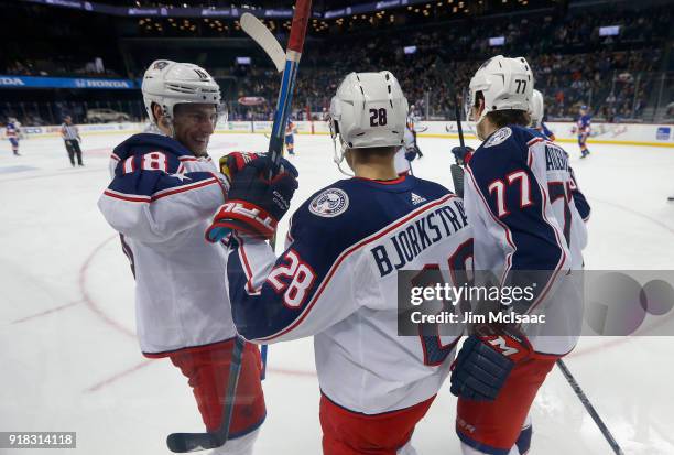 Oliver Bjorkstrand of the Columbus Blue Jackets celebrates his second-period goal against the New York Islanders with teammates Josh Anderson and...