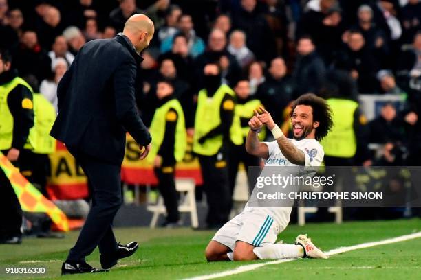 Real Madrid's Brazilian defender Marcelo celebrates with Real Madrid's French coach Zinedine Zidane after scoring during the UEFA Champions League...