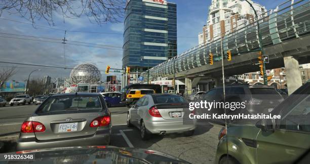 vancouver traffic near main street skytrain station - vancouver skytrain stock pictures, royalty-free photos & images