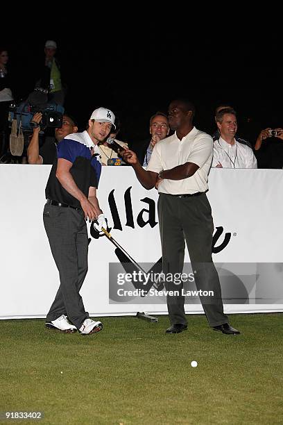 Singer Justin Timberlake speaks with Golf Channel host Scott Walker during his attempt to win a one million charitable donation to Shriners Hospitals...