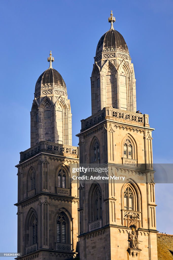 The Grossmunster towers with blue sky, illuminated by afternoon sun, Zurich, Switzerland