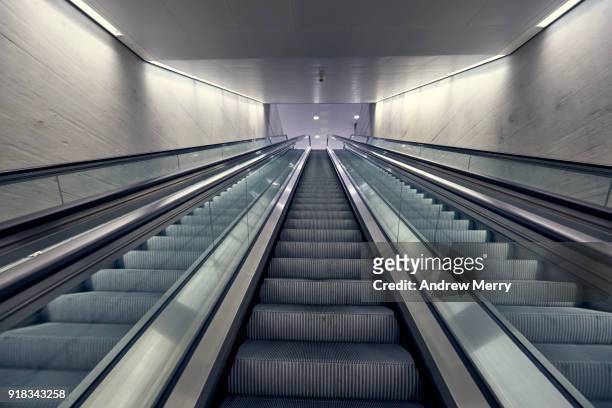 three escalators looking upward, zurich central station, switzerland - train station stock-fotos und bilder