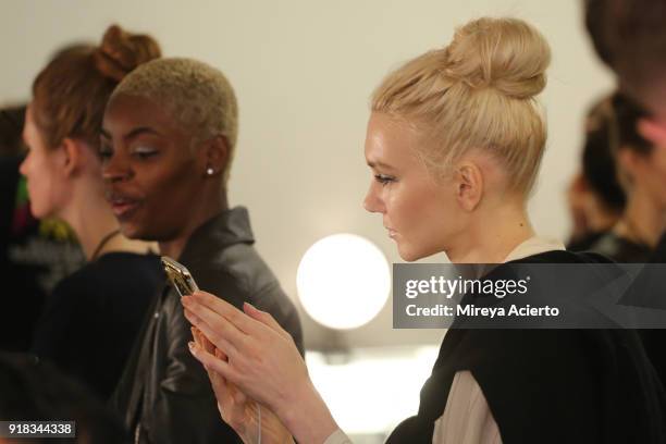 Models prepare backstage for Irina Vitjaz during New York Fashion Week: The Shows at Gallery I at Spring Studios on February 14, 2018 in New York...