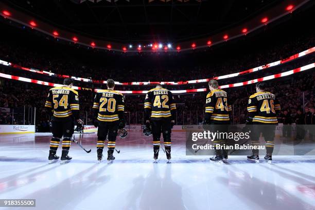 Adam McQuaid, Riley Nash, David Backes, Danton Heinen and Matt Grzelcyk of the Boston Bruins stand for the national anthem before the game against...