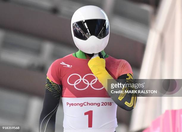 Jamaica's Anthony Watson adjusts his helmet at the end of the mens's skeleton heat 1 during the Pyeongchang 2018 Winter Olympic Games, at the Olympic...