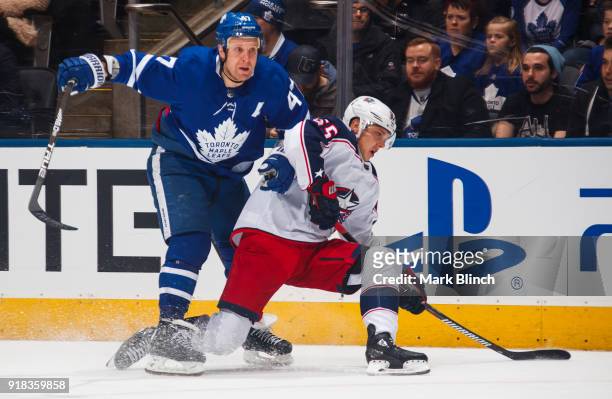 Leo Komarov of the Toronto Maple Leafs skates against Markus Nutivaara of the Columbus Blue Jackets during the first period at the Air Canada Centre...