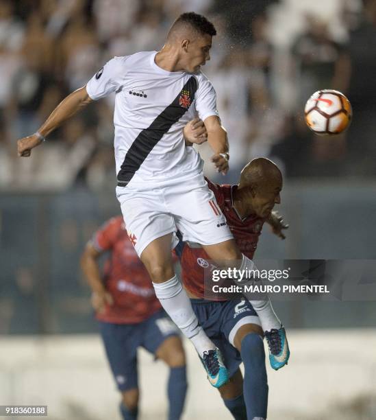 Brazil's Vasco da Gama player Paulinho heads the ball over Alex Silva of Bolivia's Jorge Wilstermann during their Libertadores Cup football match at...