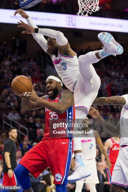 Trevor Booker of the Philadelphia 76ers goes up for a shot and is fouled by Dwyane Wade of the Miami Heat in the second quarter at the Wells Fargo...